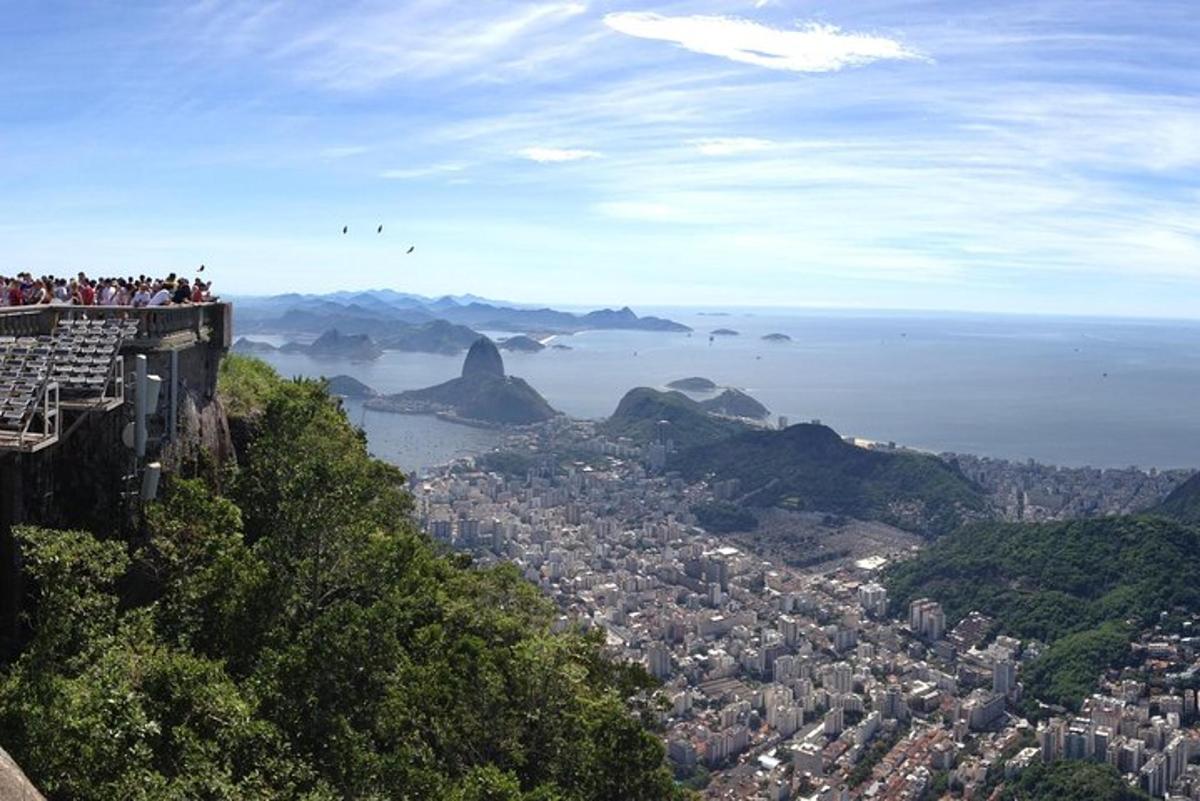 a group of people standing on the edge of a mountain