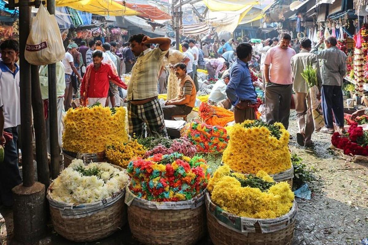 a group of people in a market with flowers