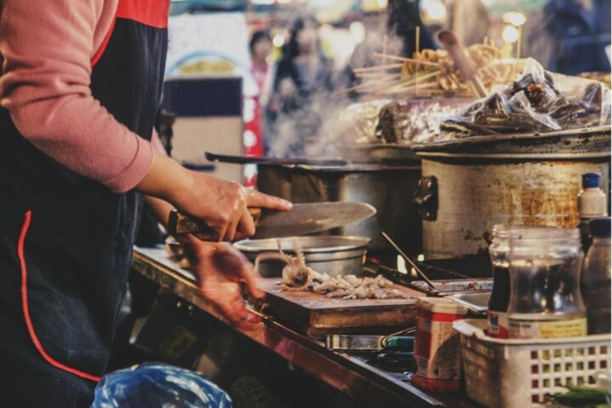 a person is preparing food on a grill