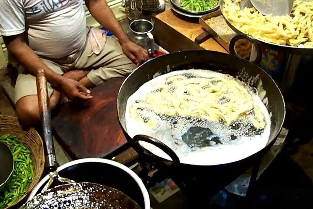 a person is cooking food in a pan