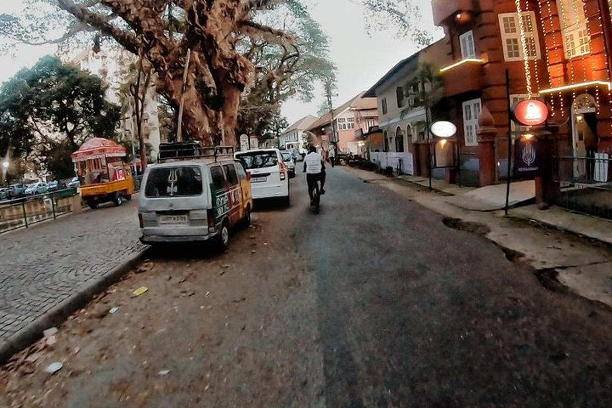 a man riding a bike down a street next to a van