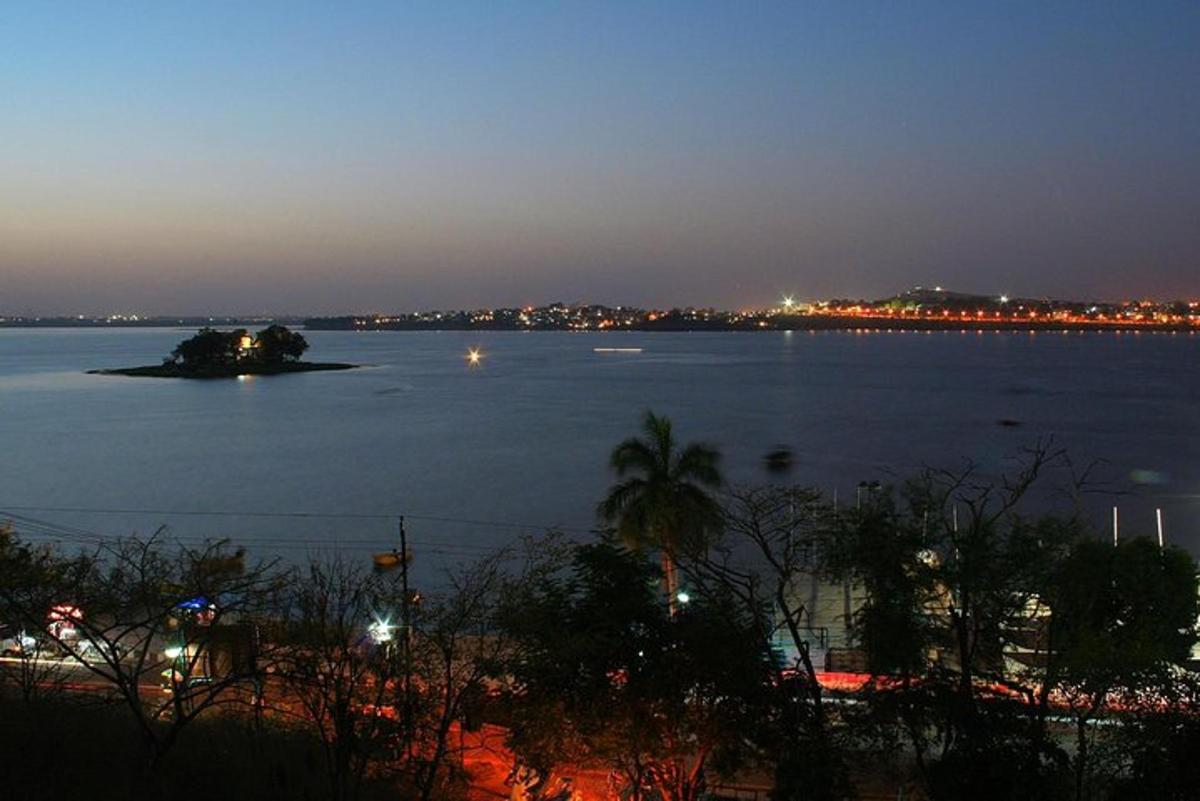 an island in a large body of water at night