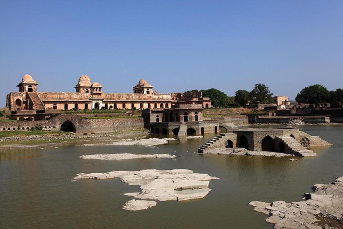 an old building with a bridge over a river