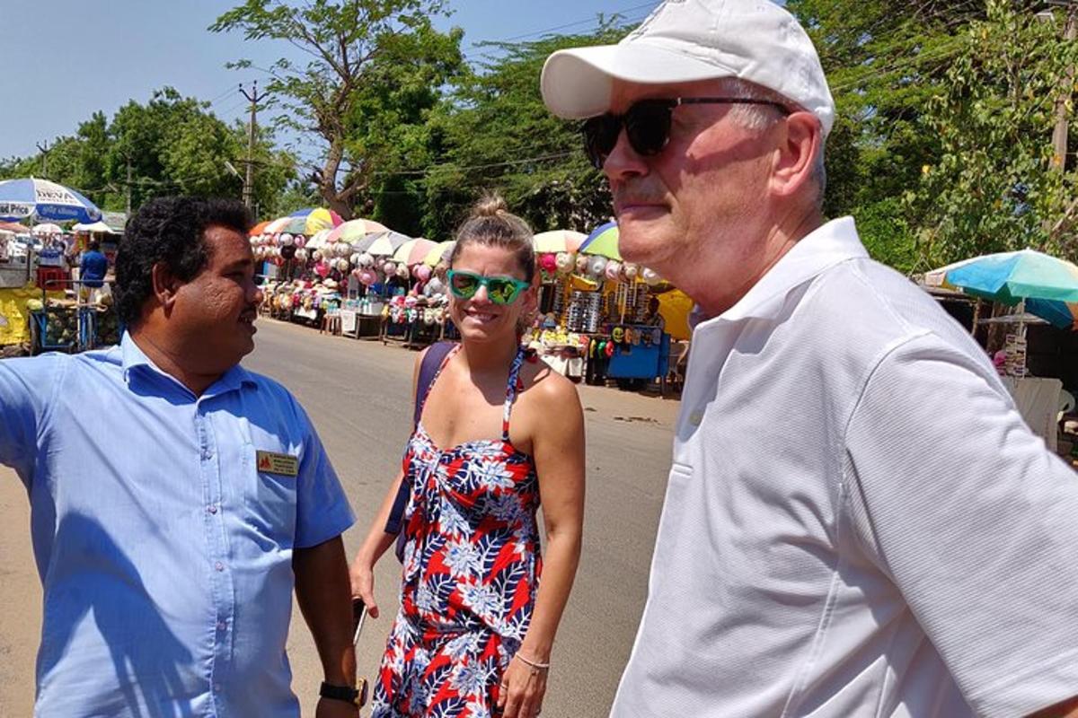 two men and a woman walking down a street