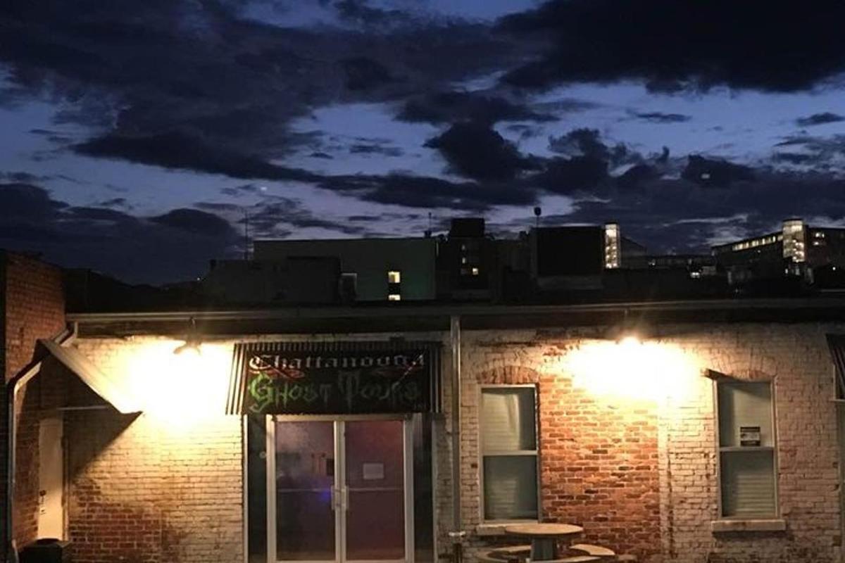 a brick building with a sign on it at night