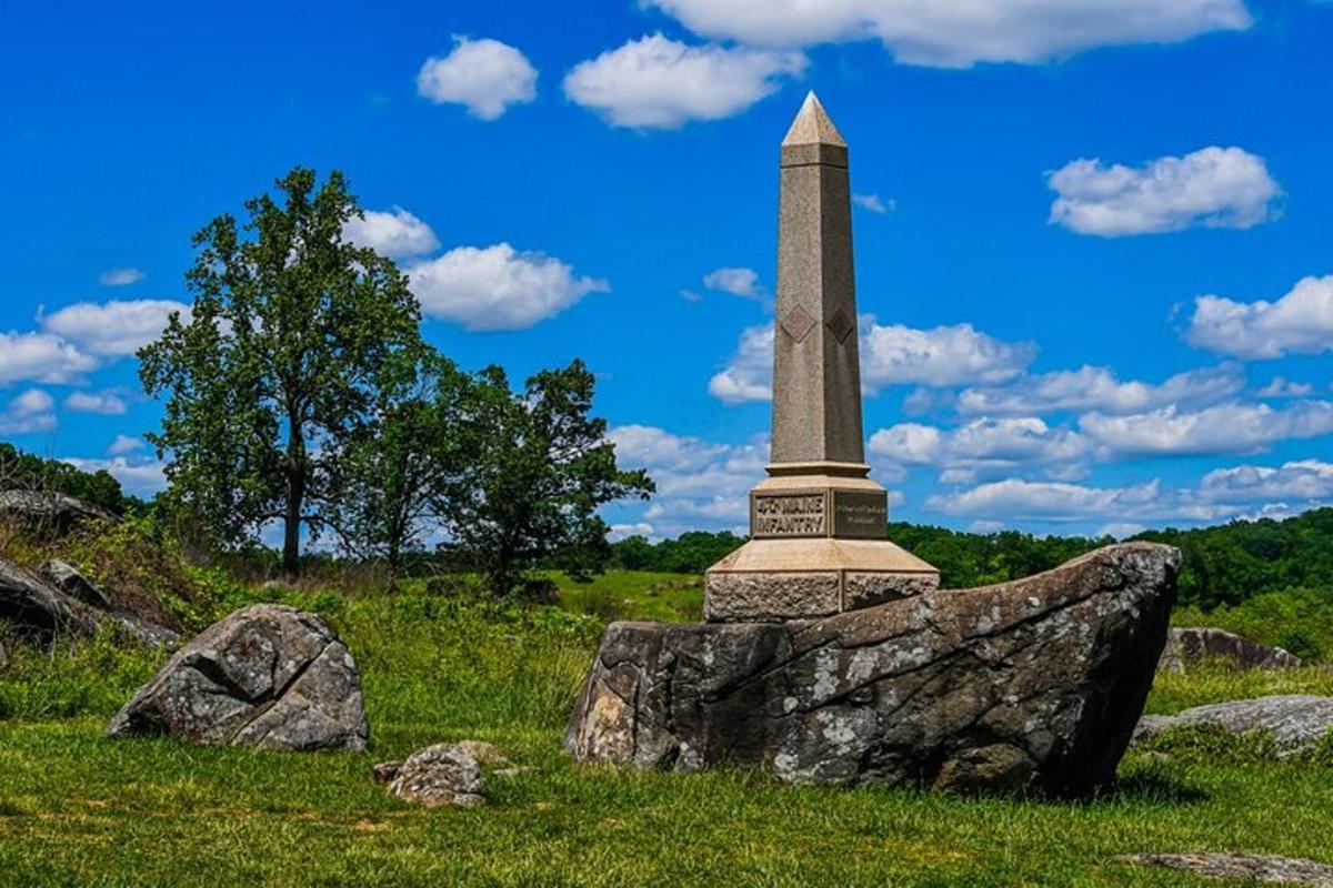 a monument on top of a rock in a field