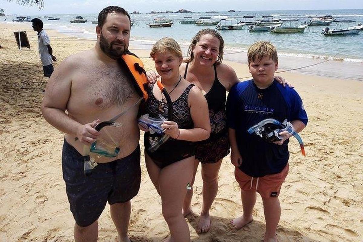 un homme, une femme et deux enfants sur la plage