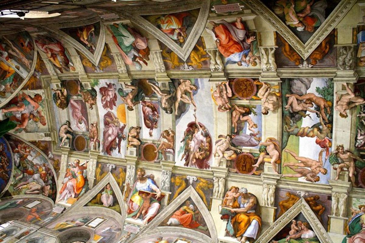 a wall with paintings on the ceiling of a church