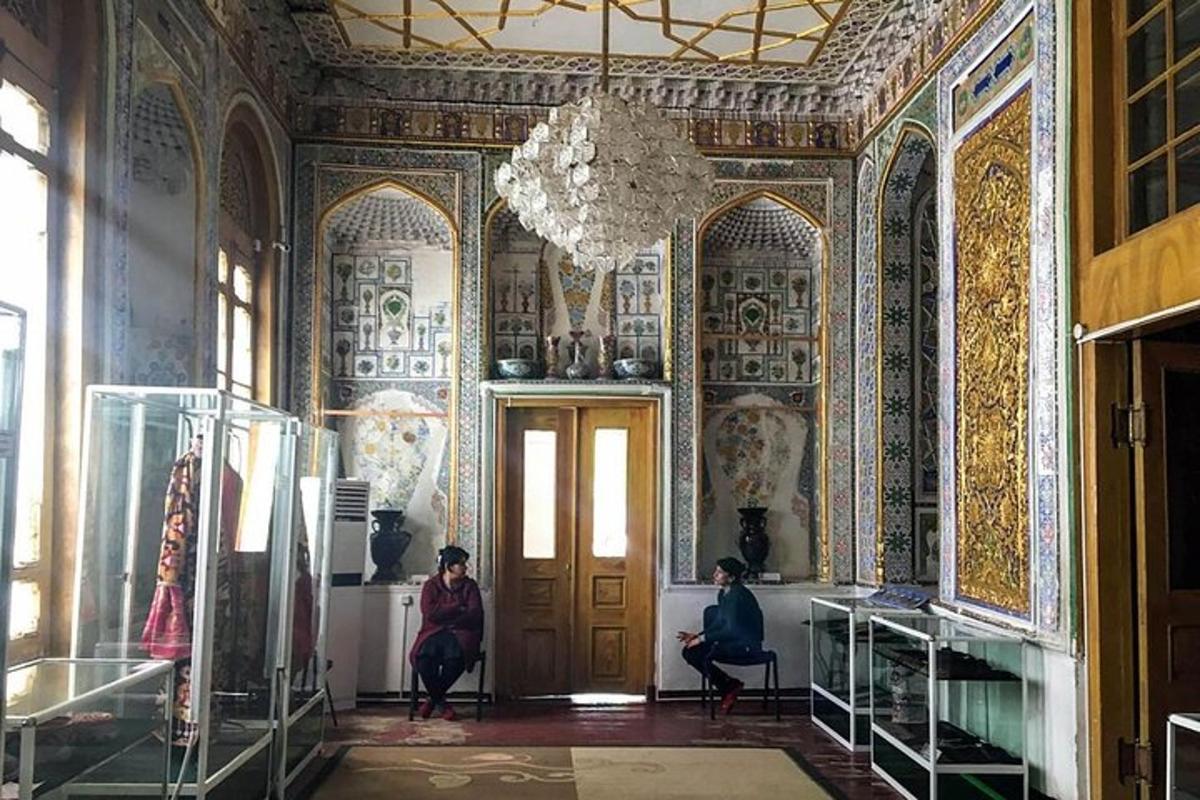 two people sitting in a room with a chandelier