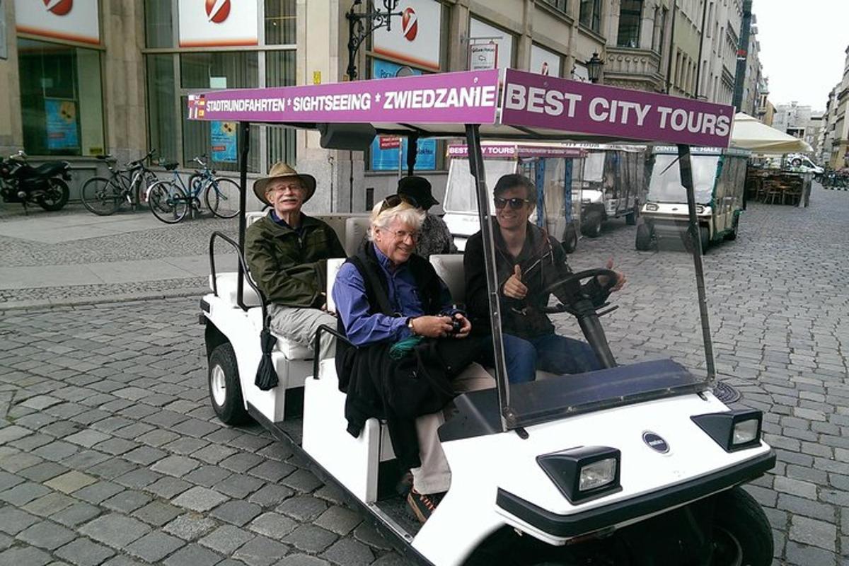 a group of people riding on a golf cart