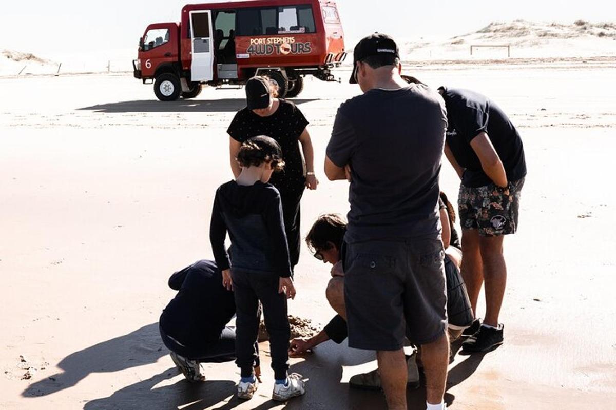 a group of people standing on the beach