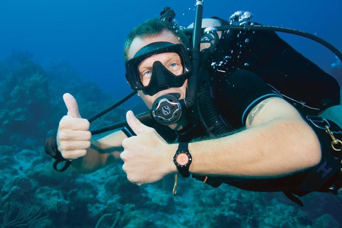 a man in a diving mask giving a thumbs up