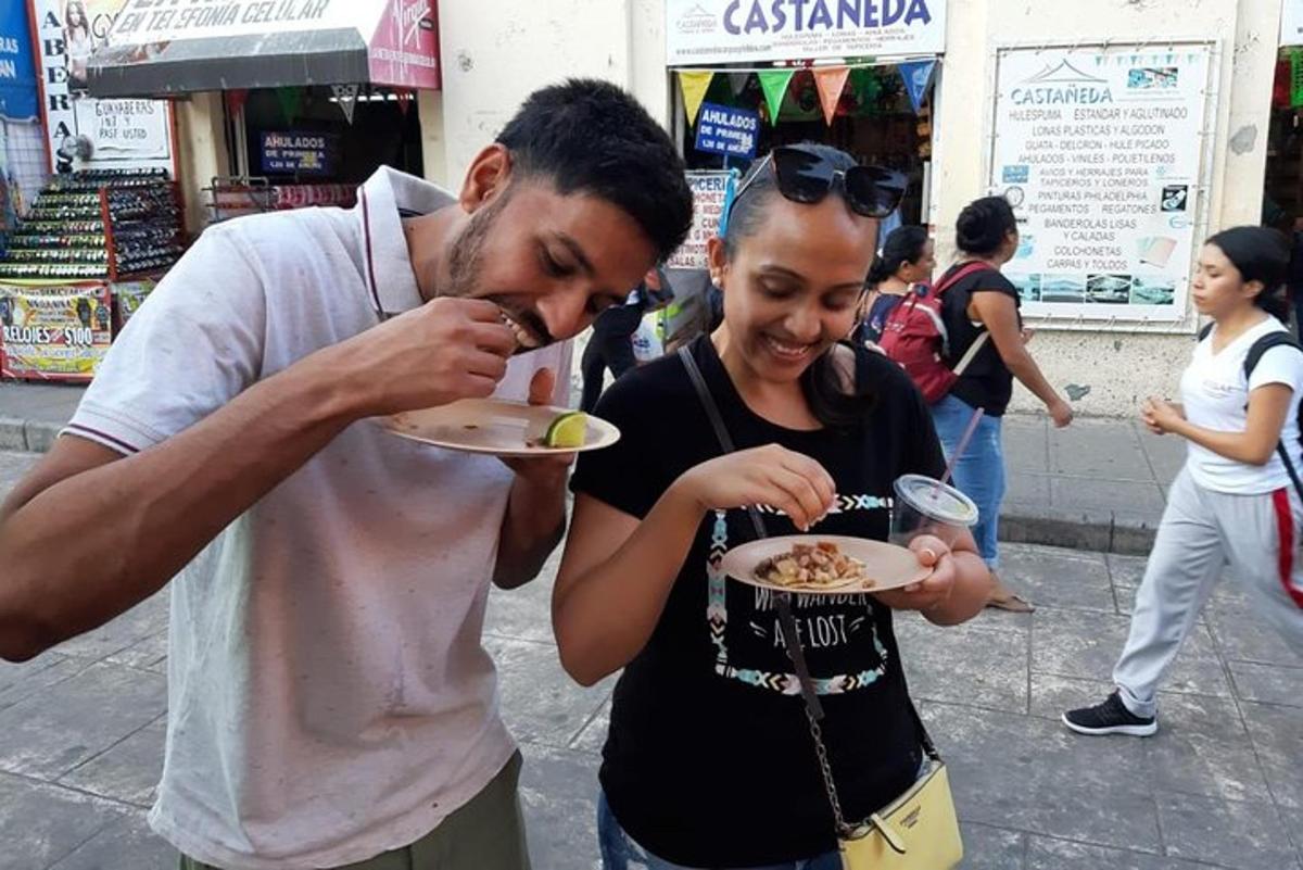 a man feeding a woman a plate of food