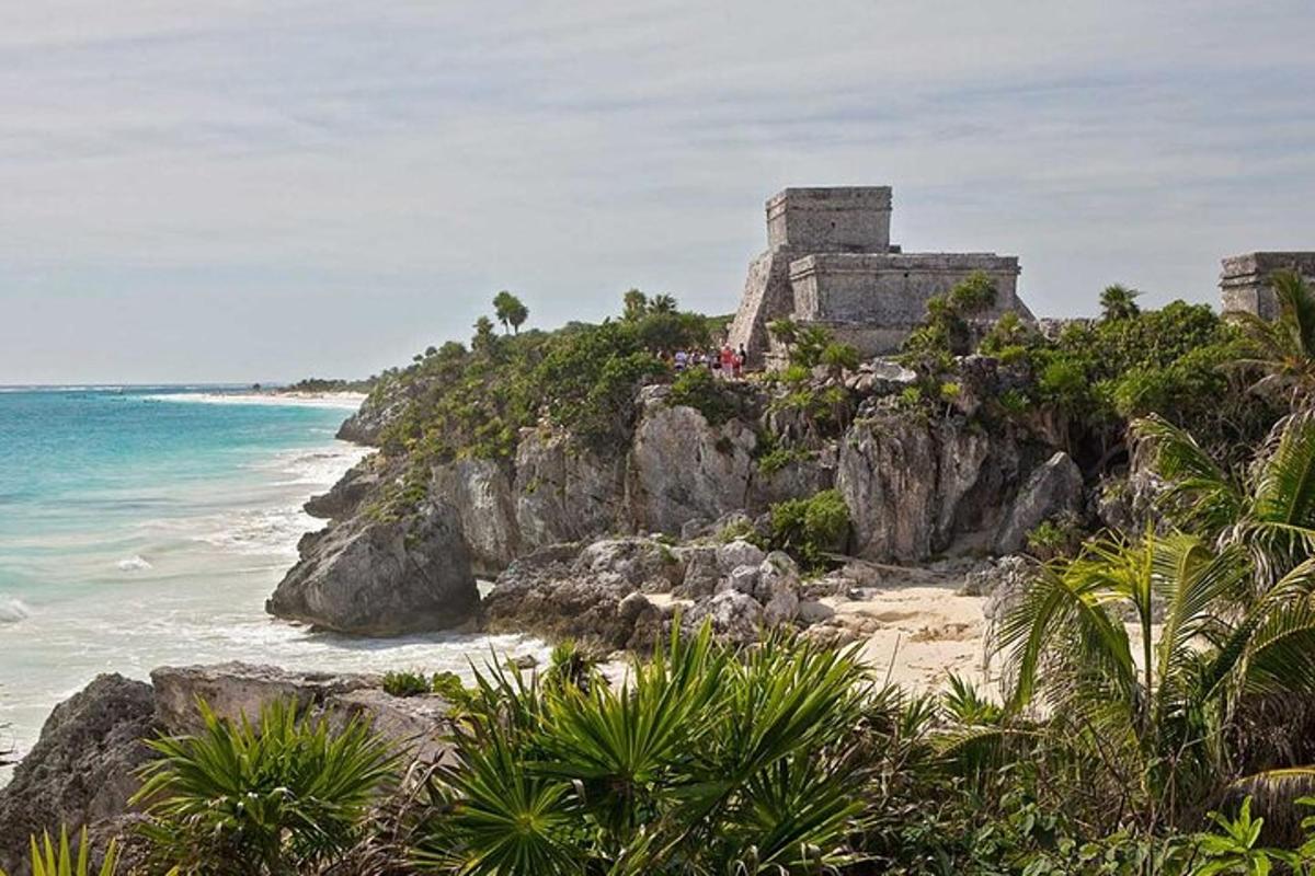 a castle on a cliff next to the ocean