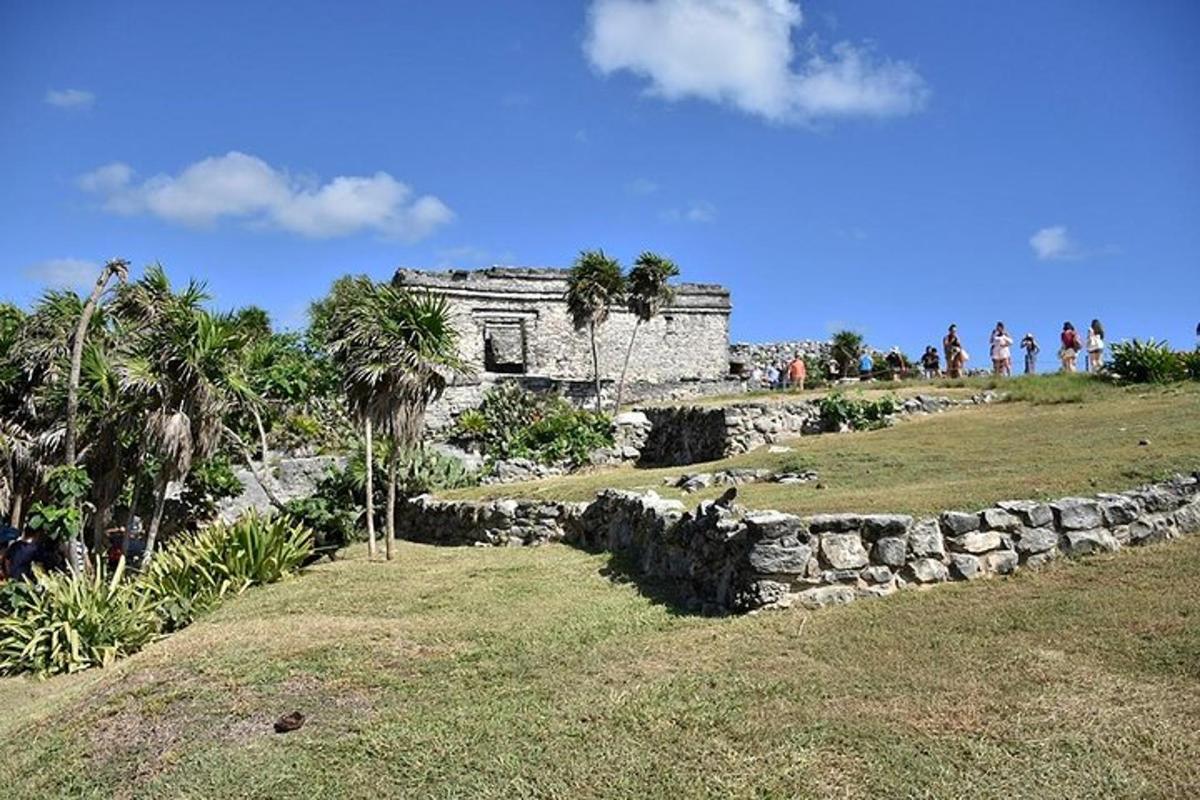 an old stone building on a hill with palm trees