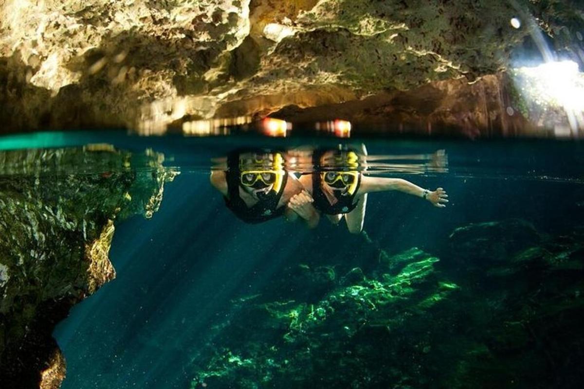 a man in a pool of water in a cave