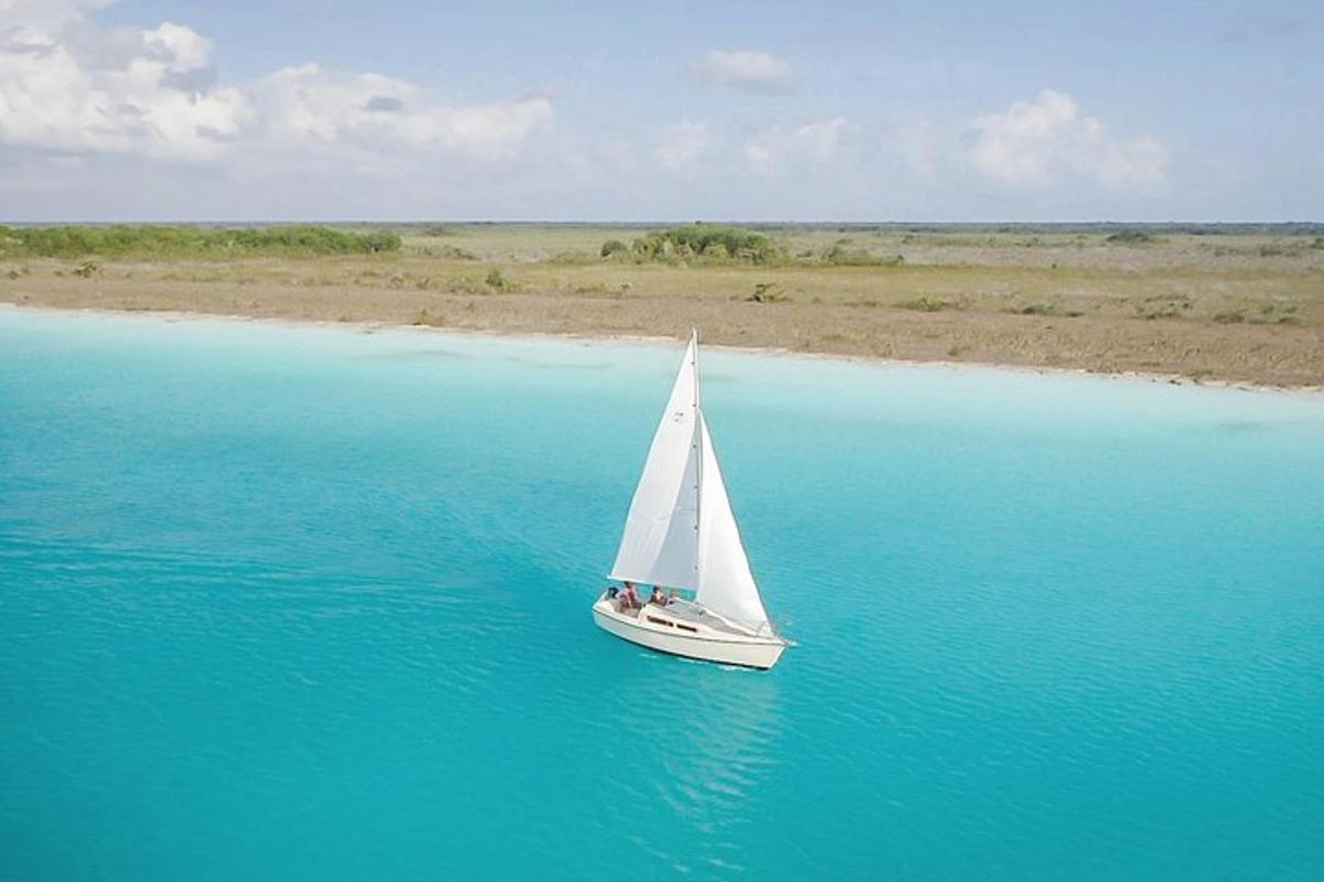 a sailboat in the middle of a body of water