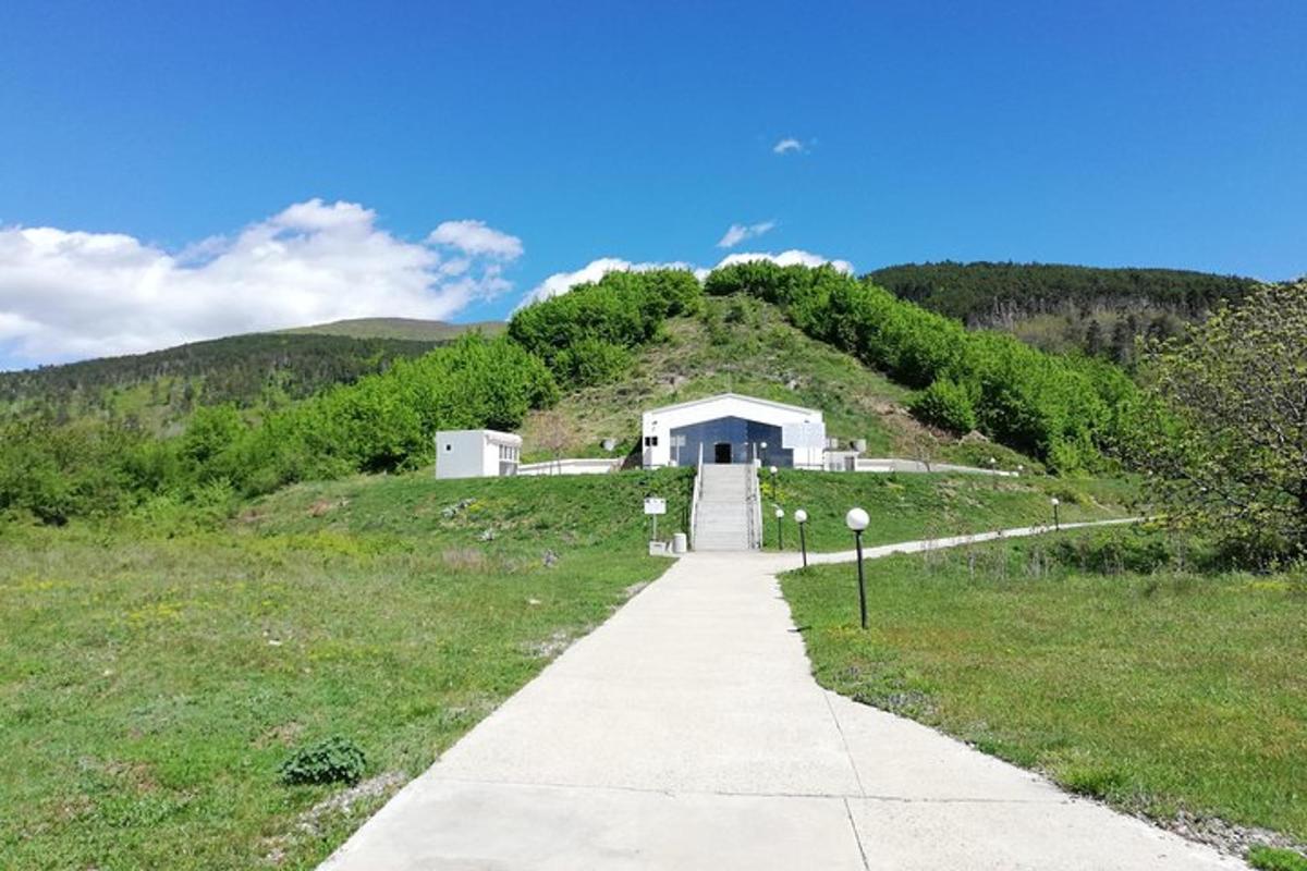 a house on top of a hill with a sidewalk