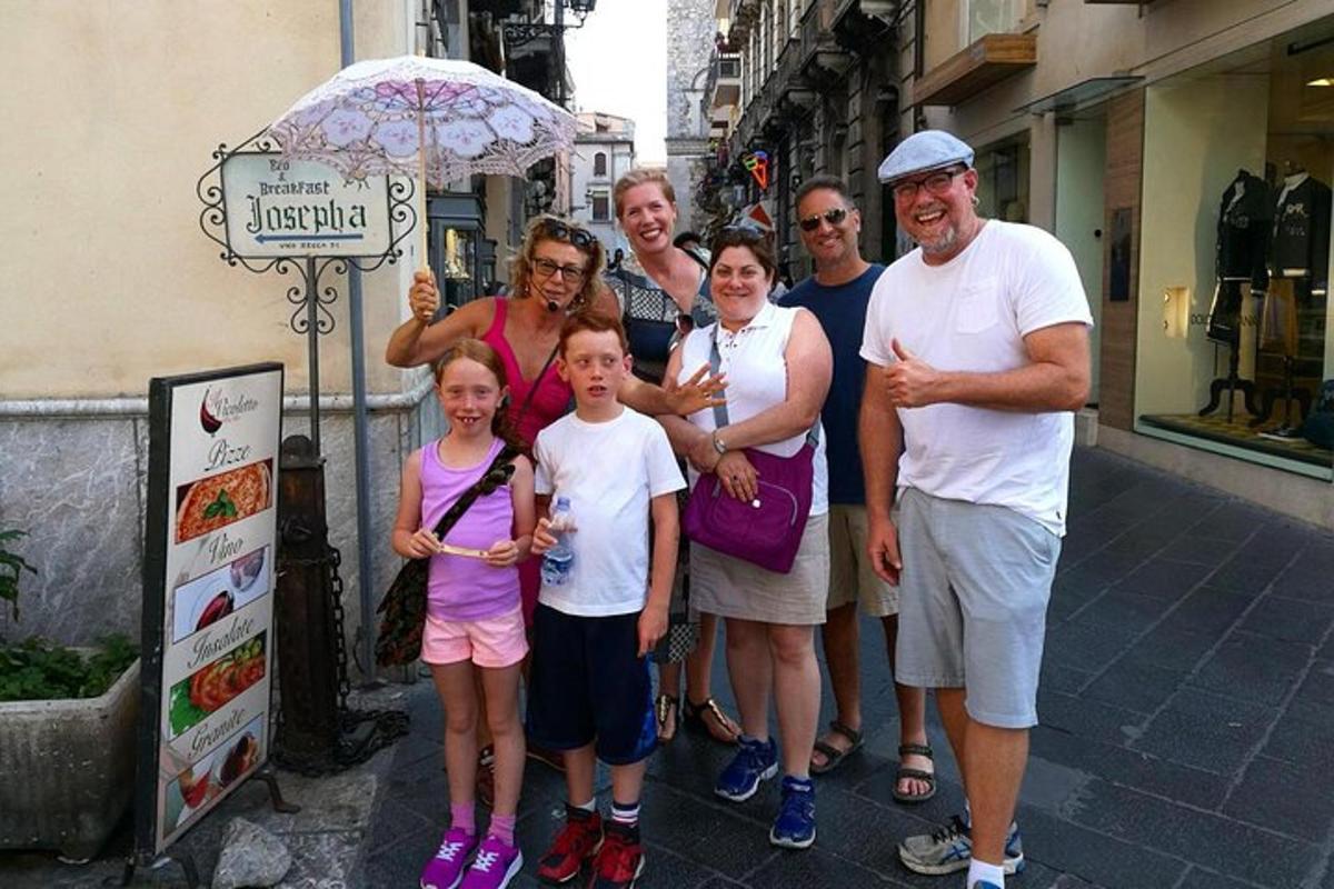a group of people posing for a picture on a street