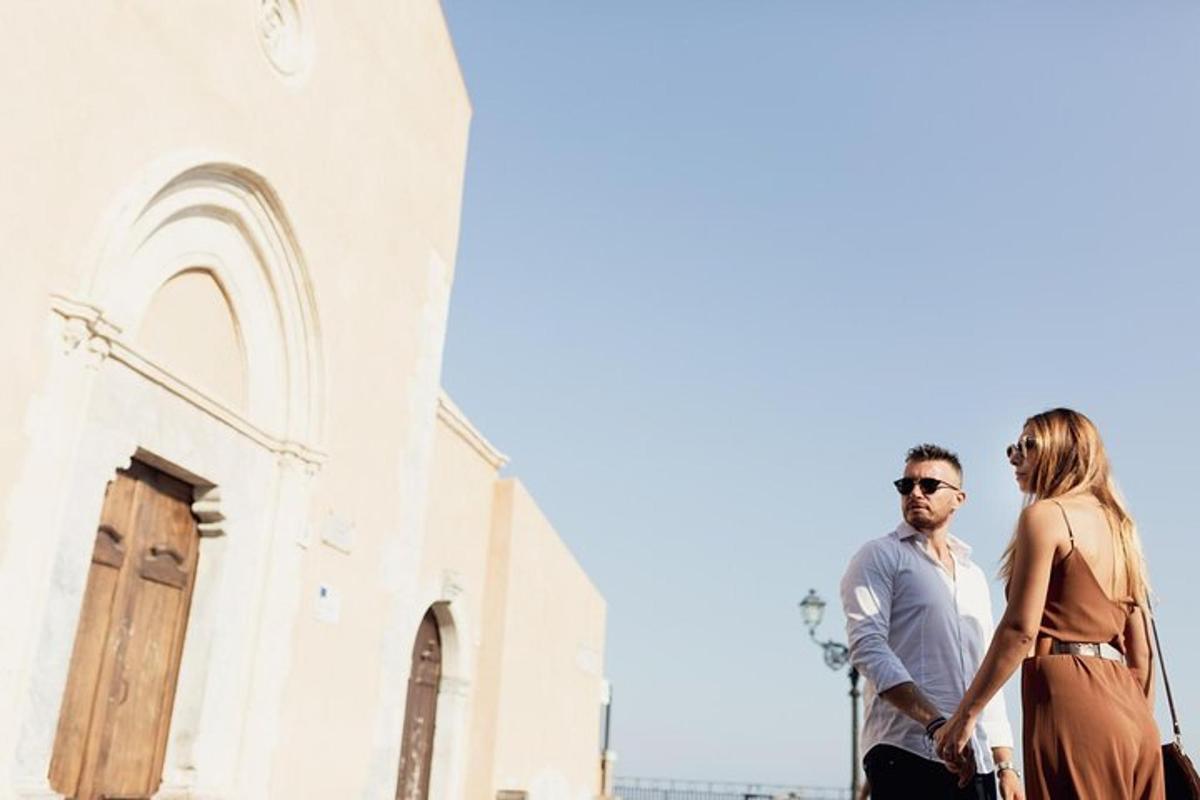 a man and a woman standing in front of a church