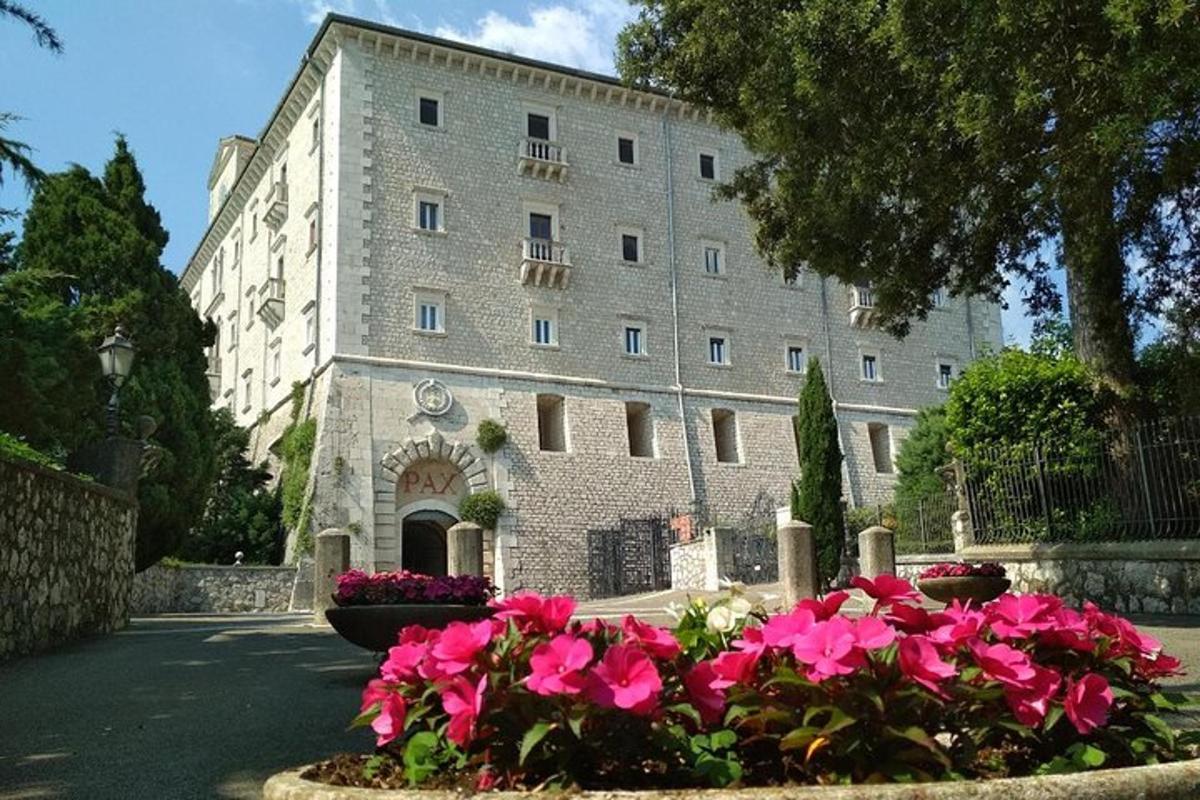 a large building with pink flowers in front of it