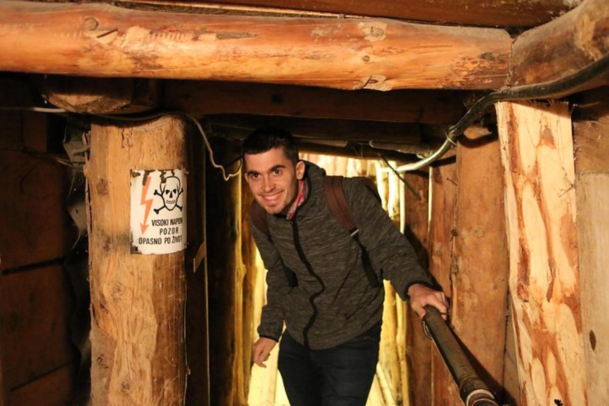 a man standing in a room with a pipe