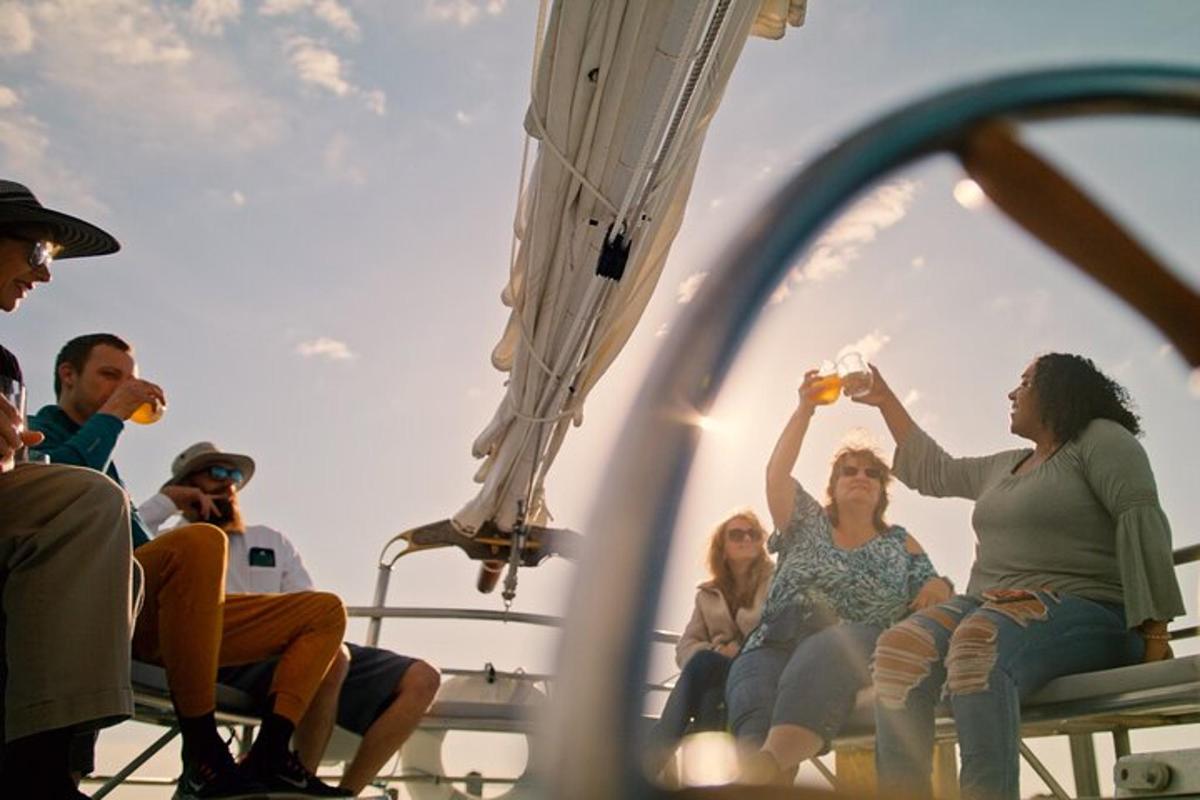 a group of people sitting on the deck of a boat