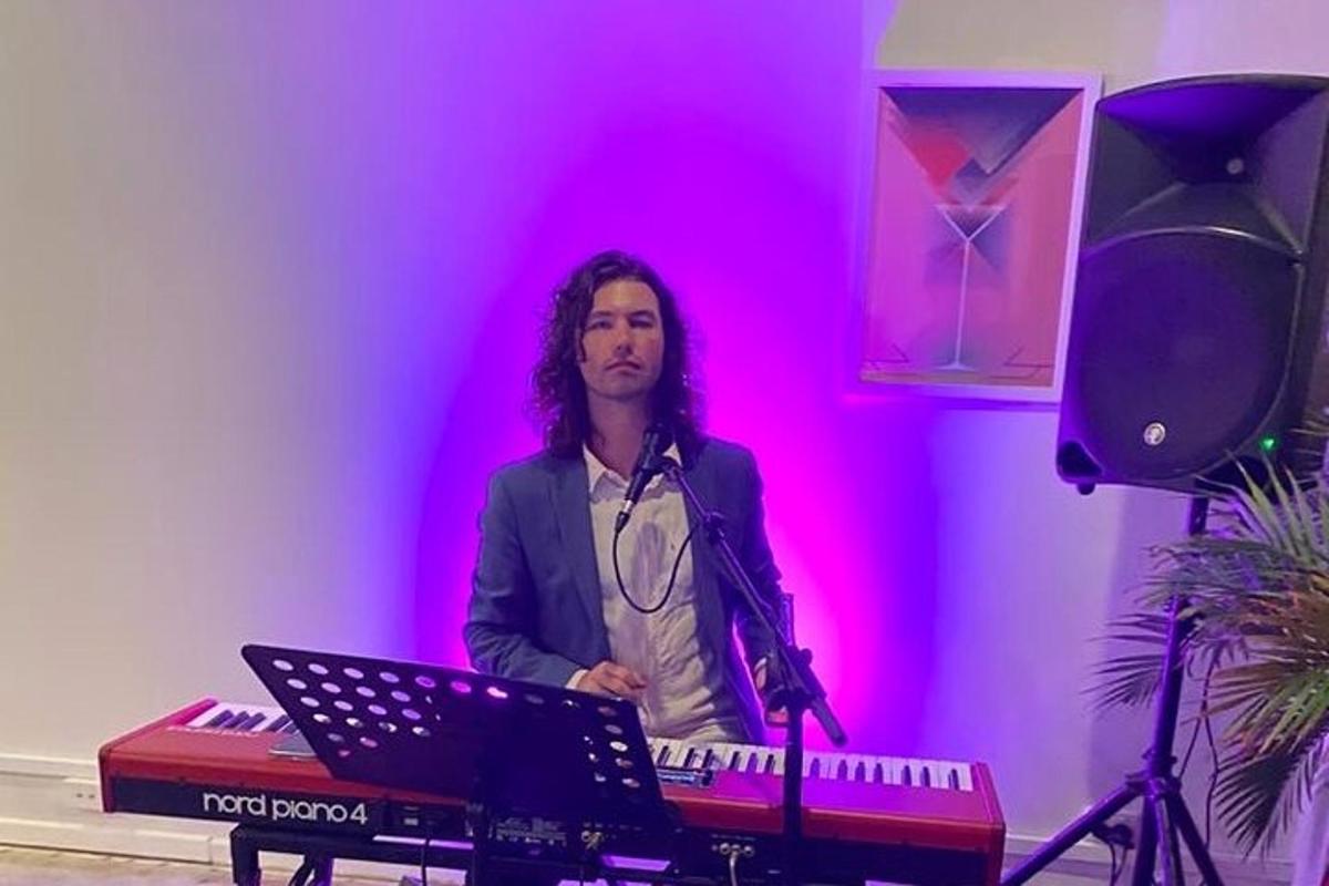 a man standing in a room with a keyboard
