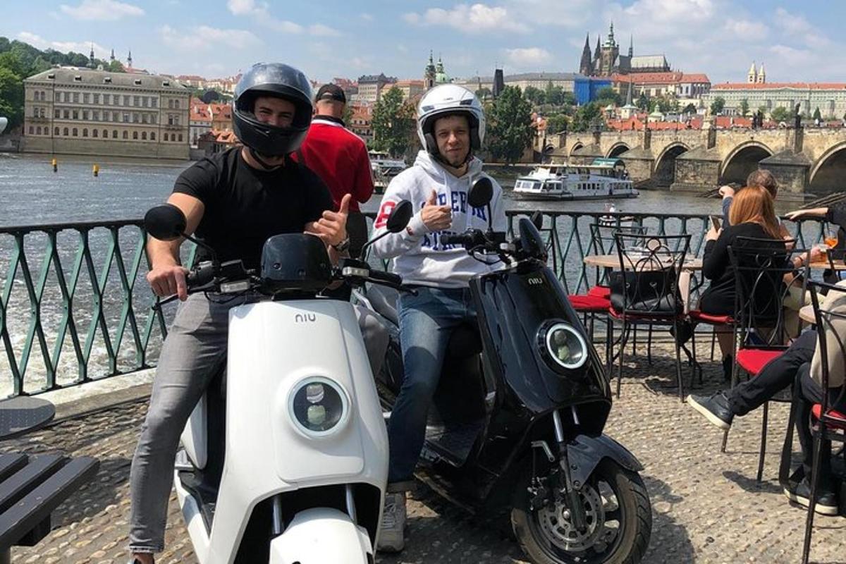 two people are sitting on motorcycles on a bridge
