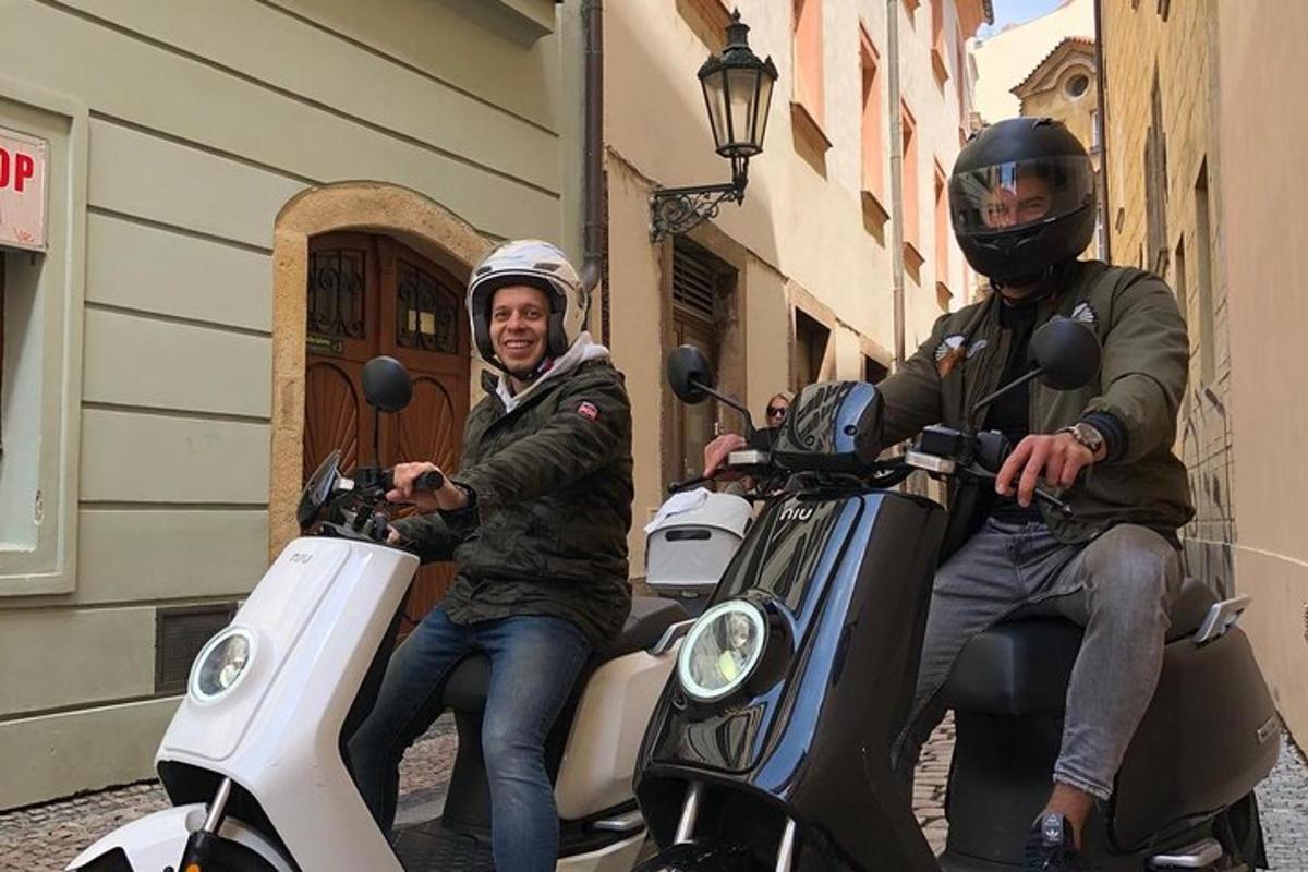 two men are sitting on motorcycles on a street