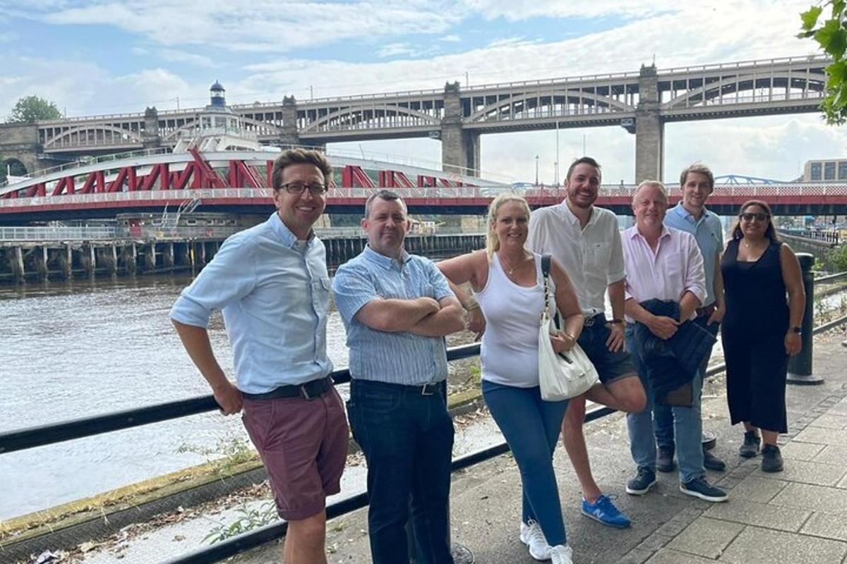 a group of people standing in front of a river