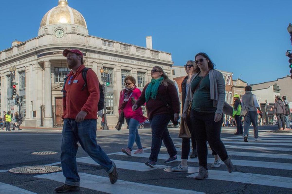 a group of people crossing a street in a crosswalk