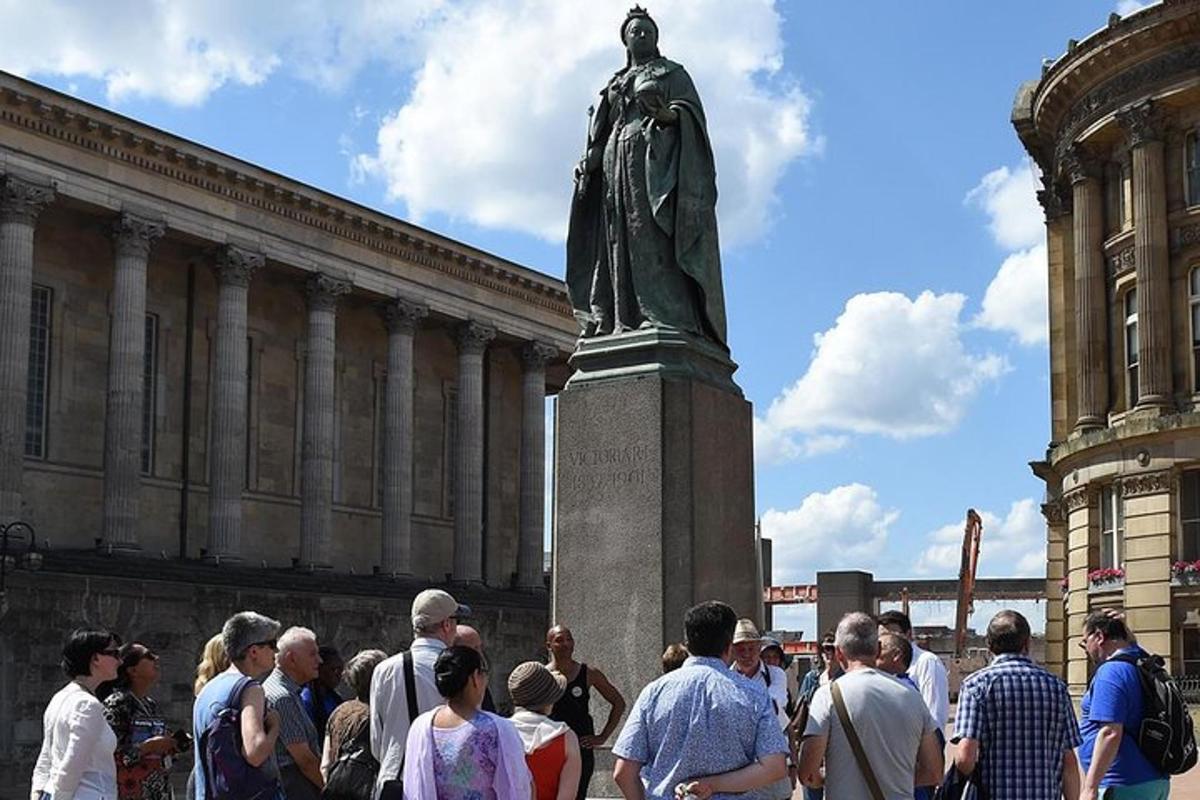 a crowd of people standing in front of a statue
