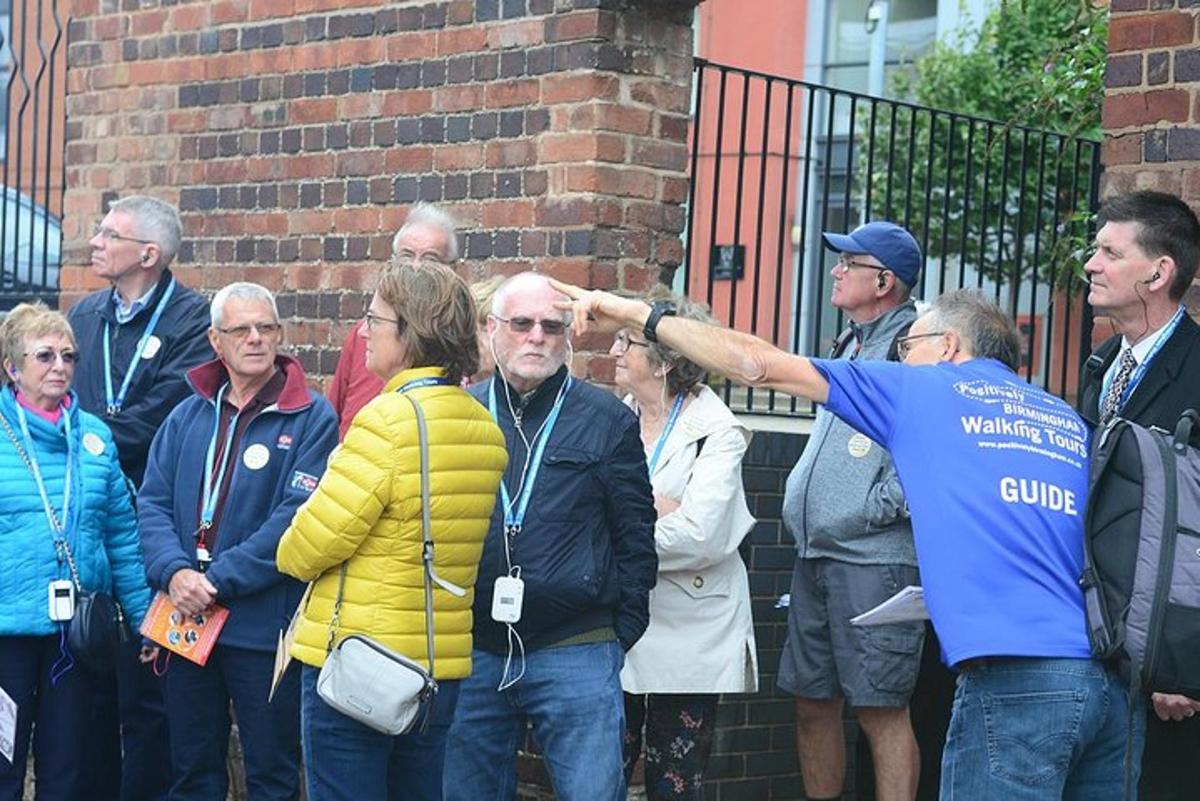 a group of people standing in front of a brick wall
