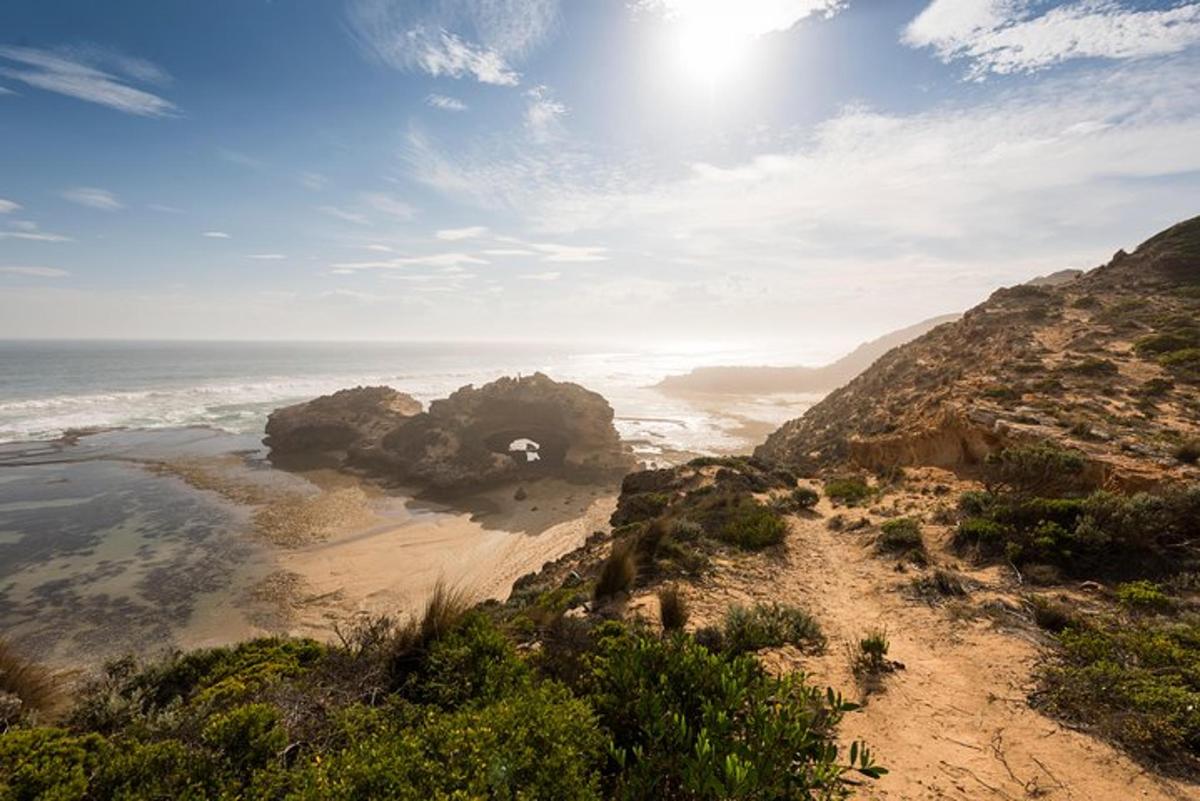 a view of a beach with rocks and the ocean