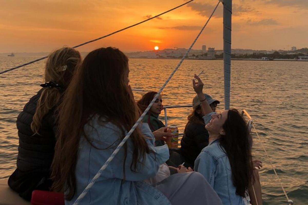 a group of women sitting on a boat at sunset