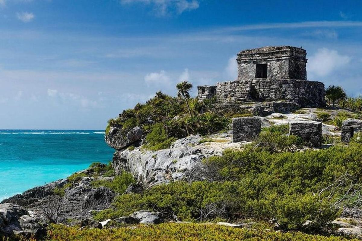 an old building on a hill near the ocean