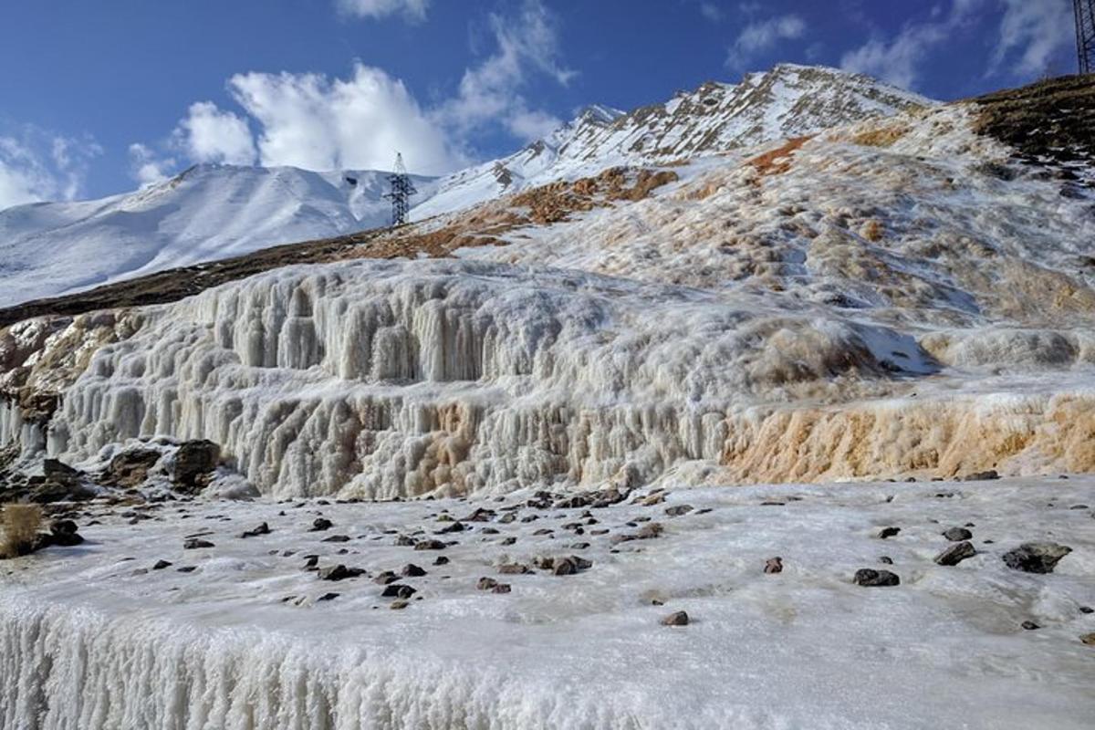 водопад на планини са снегом на њему