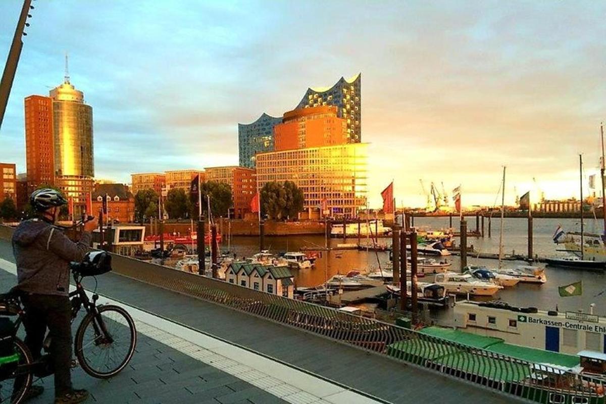 a man on a bike taking a picture of a harbor