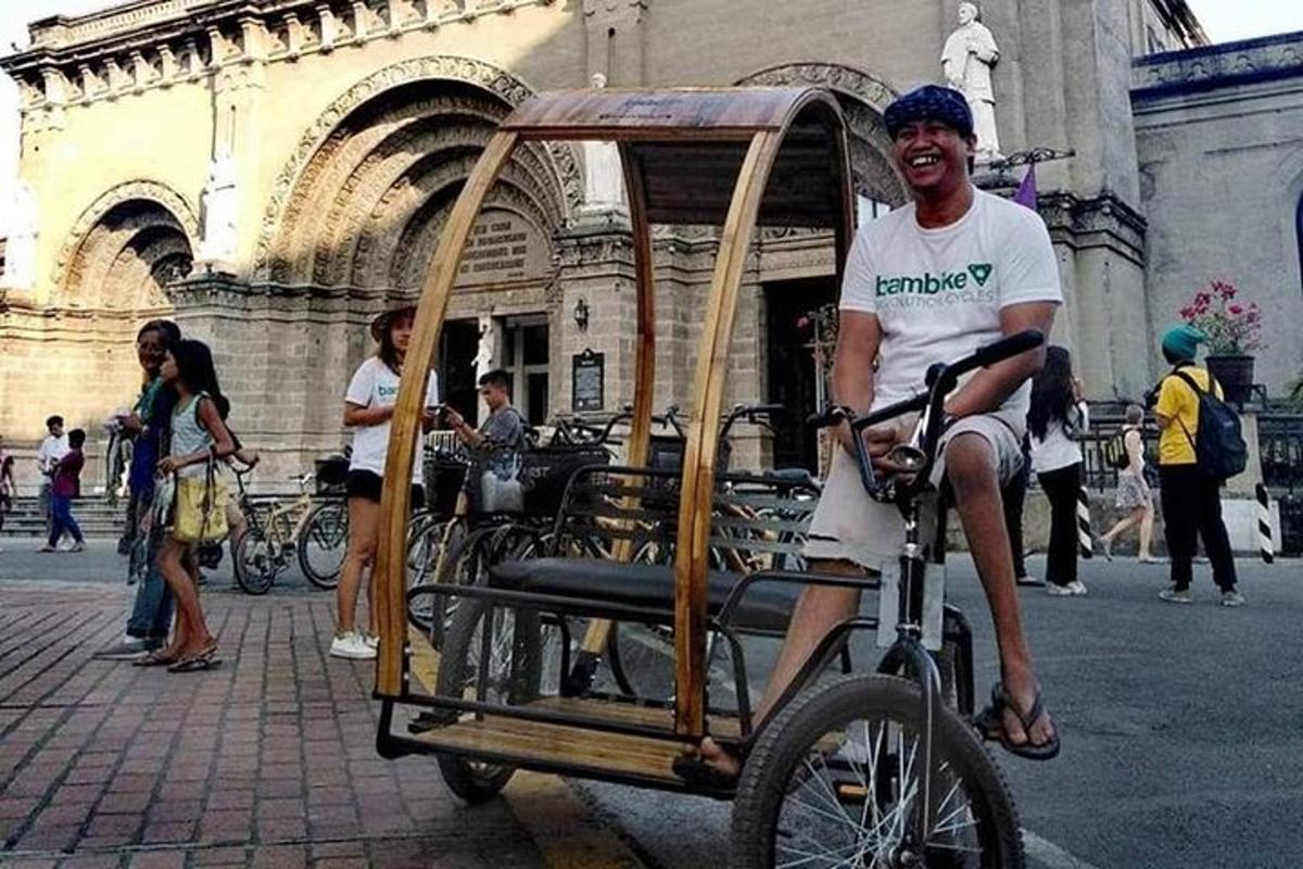 a man riding a bike with a cart on it