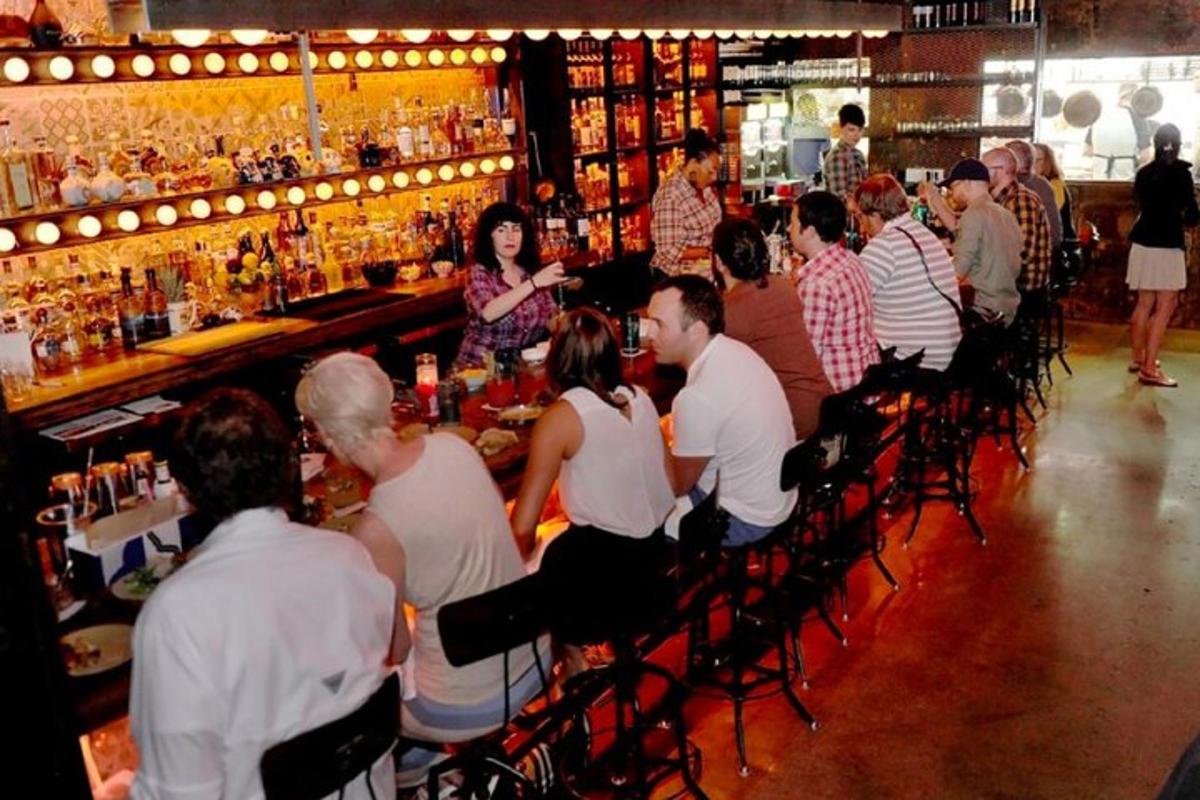 a group of people sitting at a bar