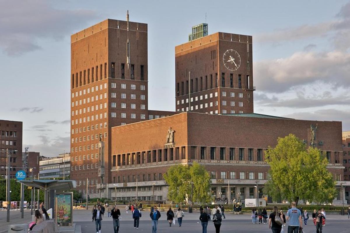 a group of people walking in front of a building with a clock tower
