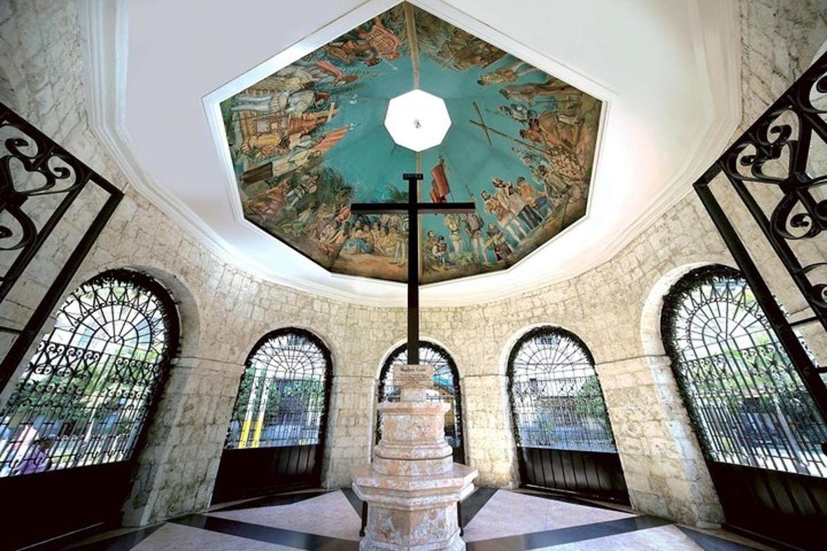 a church with a cross and a painting on the ceiling