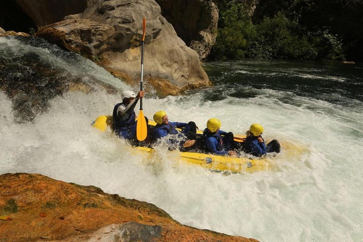 a group of people in a raft in a river