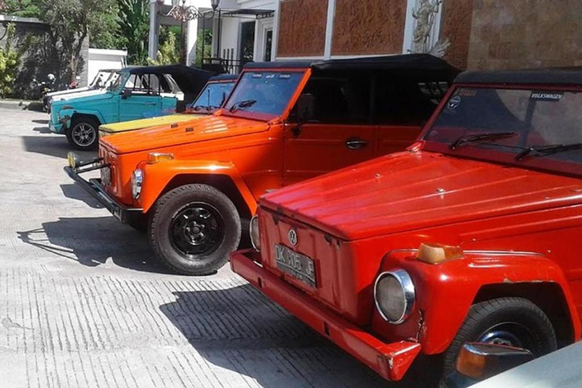 two orange trucks parked next to each other on a street