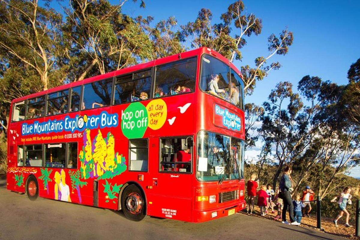 a red double decker bus driving down a street