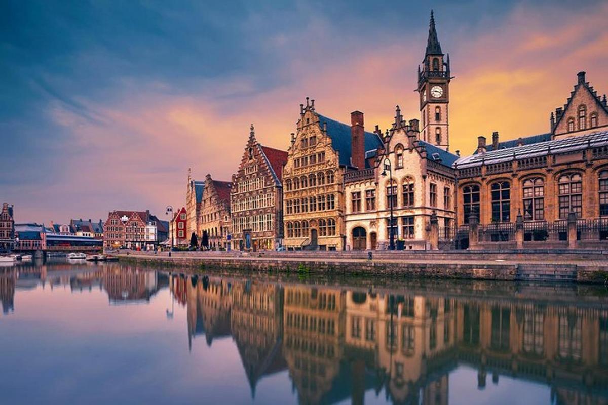 a large building with a clock tower and a river