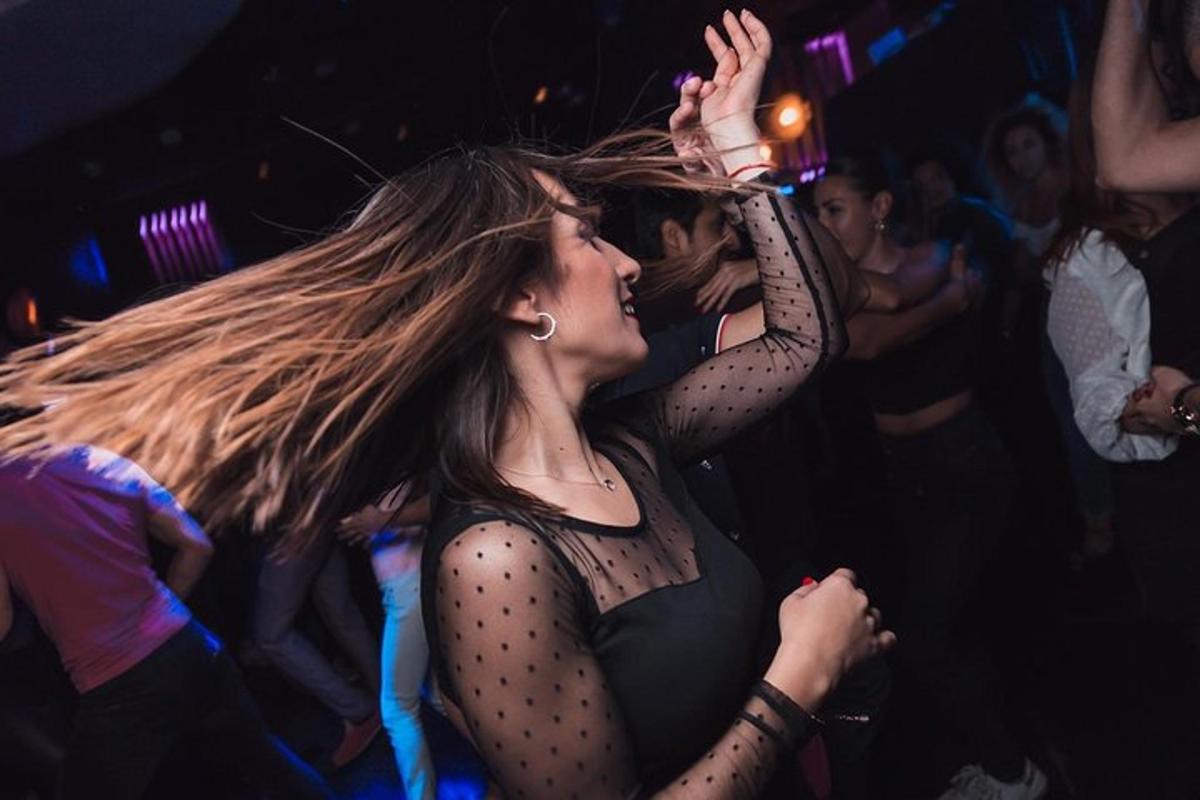 a woman dancing in a club with her hair