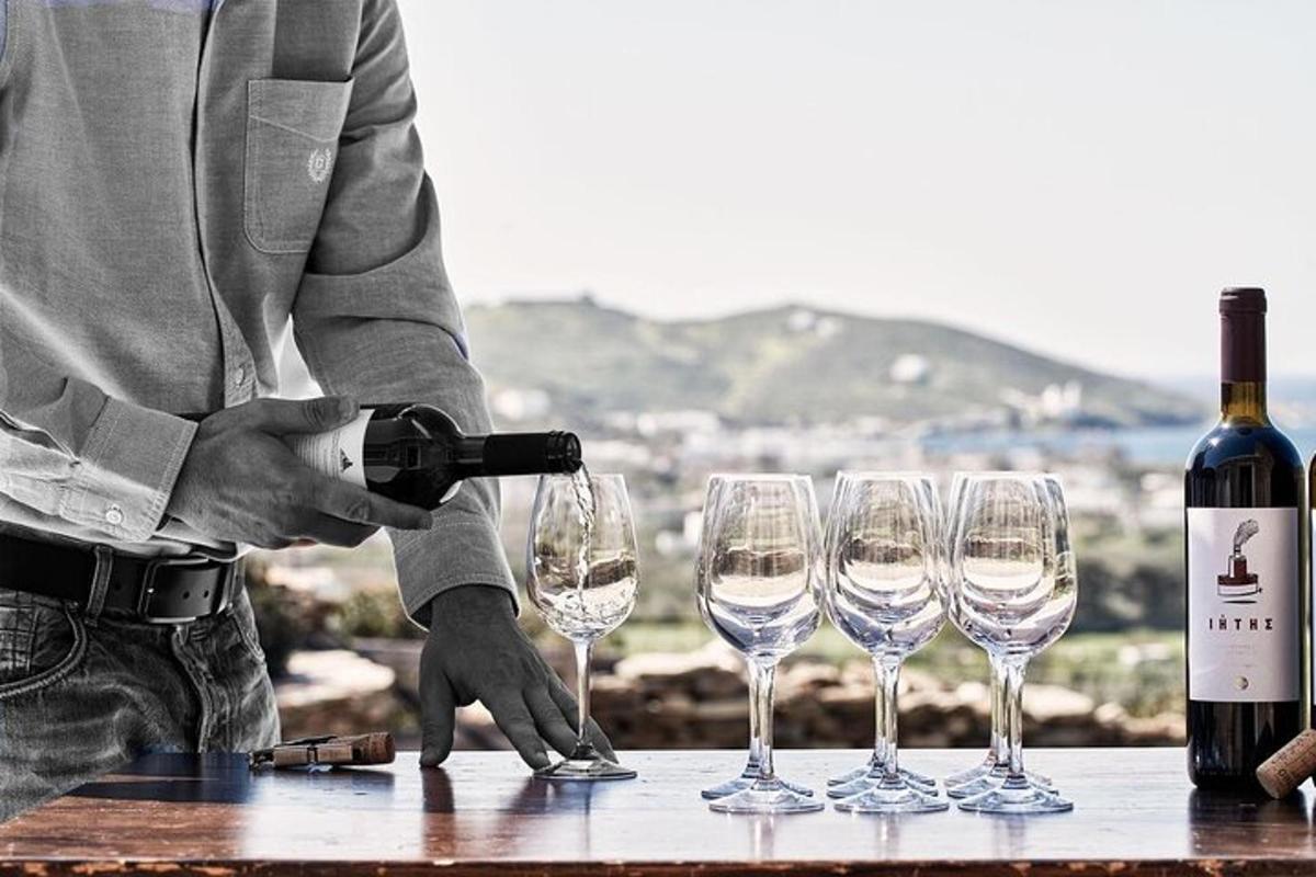 a man is pouring wine in wine glasses