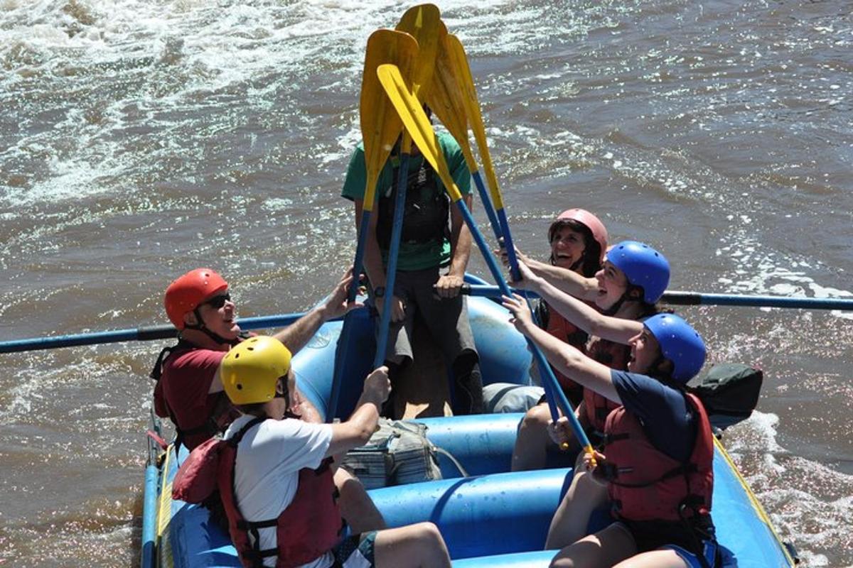 a group of people on a raft in the water